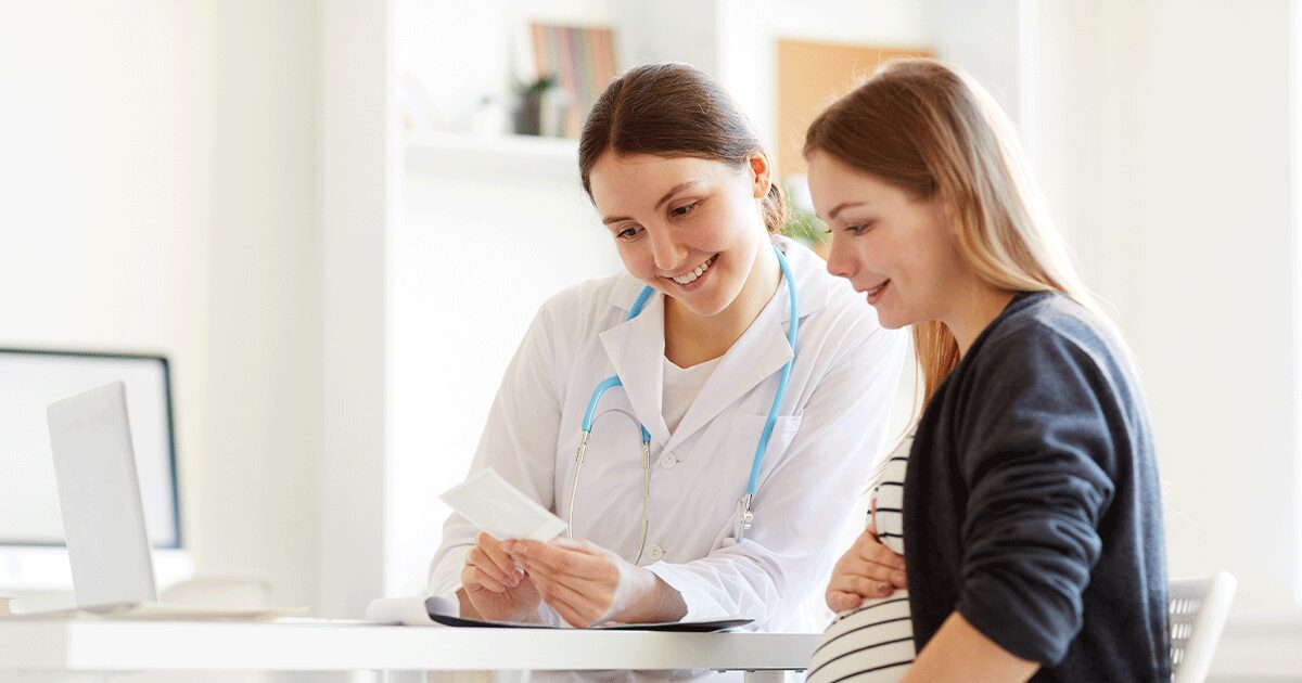 Healthcare professional providing pre-abortion care, pregnancy information, and support during a confidential consultation.