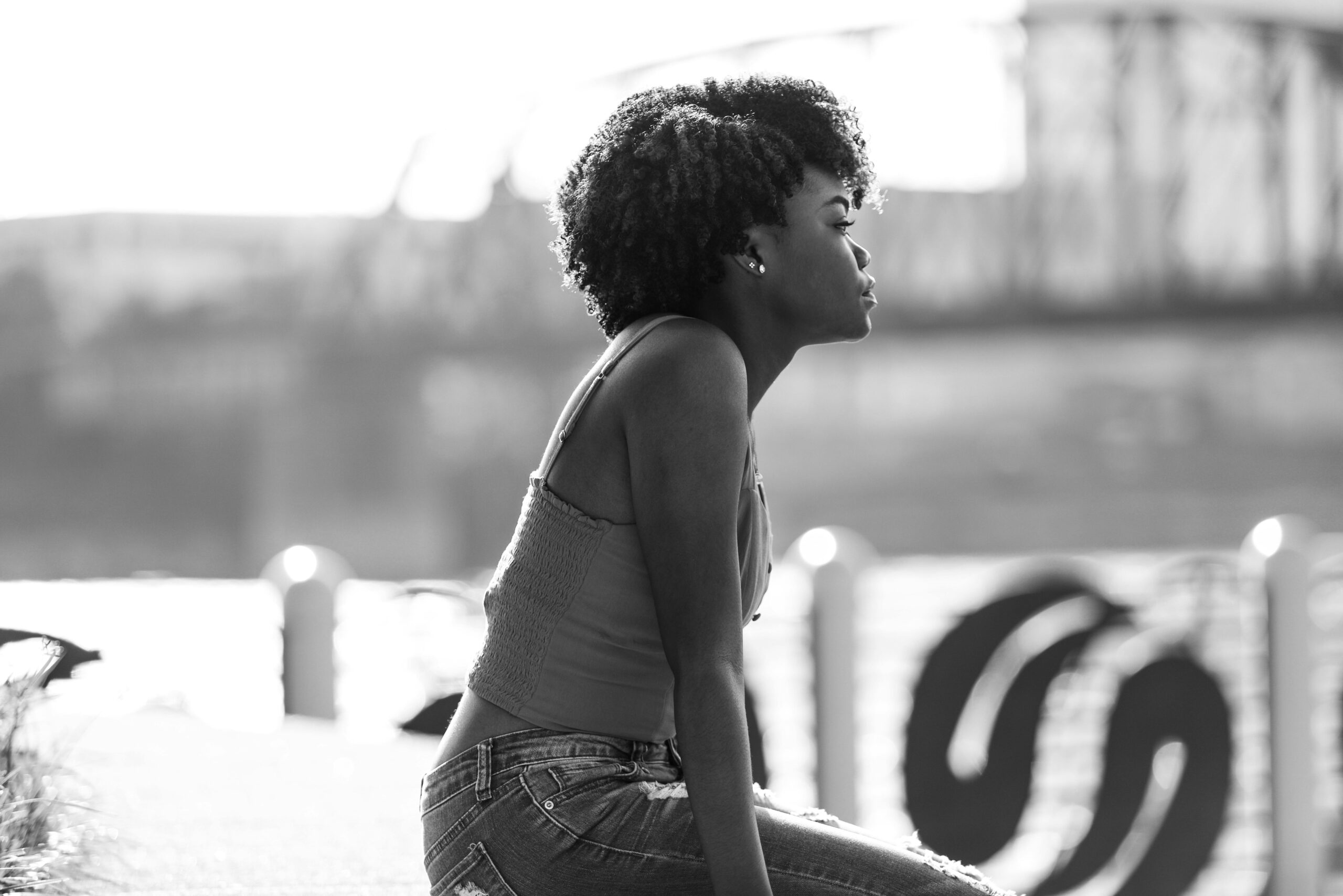 Woman looking into the distance while learning how a medical abortion works and its potential risks.